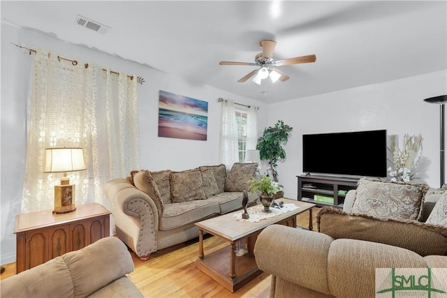 living room featuring light hardwood / wood-style flooring and ceiling fan