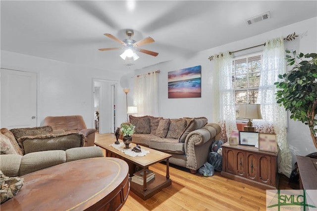 living room with ceiling fan and light hardwood / wood-style floors