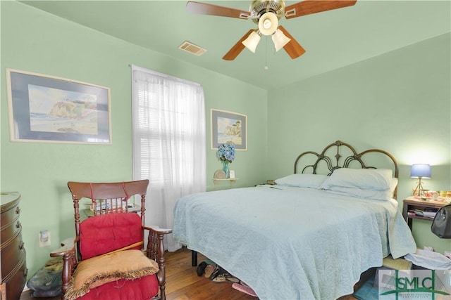 bedroom with wood-type flooring and ceiling fan