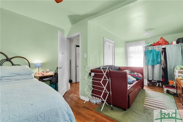 bedroom with dark hardwood / wood-style floors