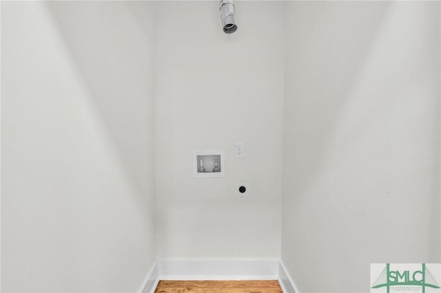 clothes washing area with wood-type flooring, washer hookup, and hookup for an electric dryer