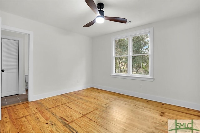 spare room featuring hardwood / wood-style flooring and ceiling fan