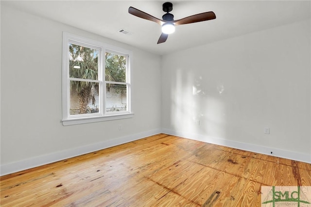 spare room with ceiling fan and wood-type flooring