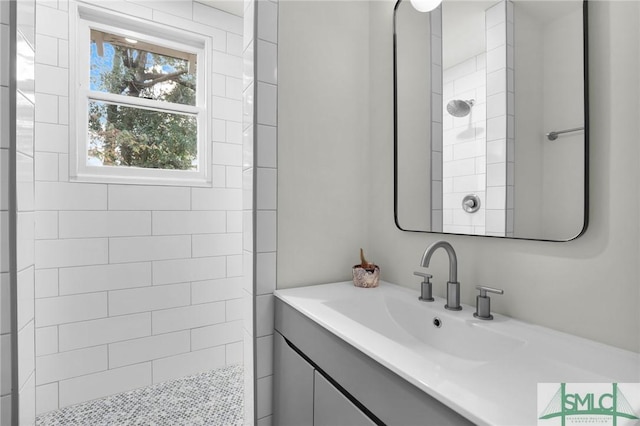 bathroom with vanity and tiled shower