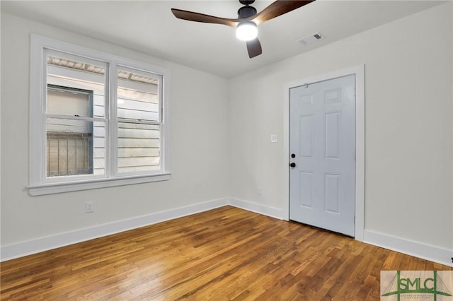 spare room with hardwood / wood-style flooring and ceiling fan