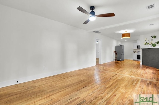 unfurnished living room with ceiling fan and light wood-type flooring