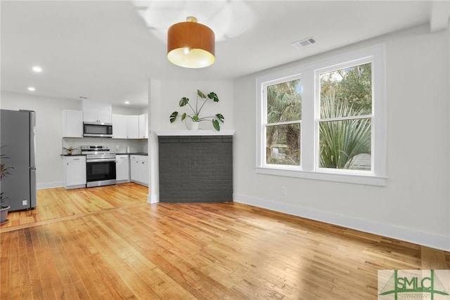 unfurnished living room with light wood-type flooring