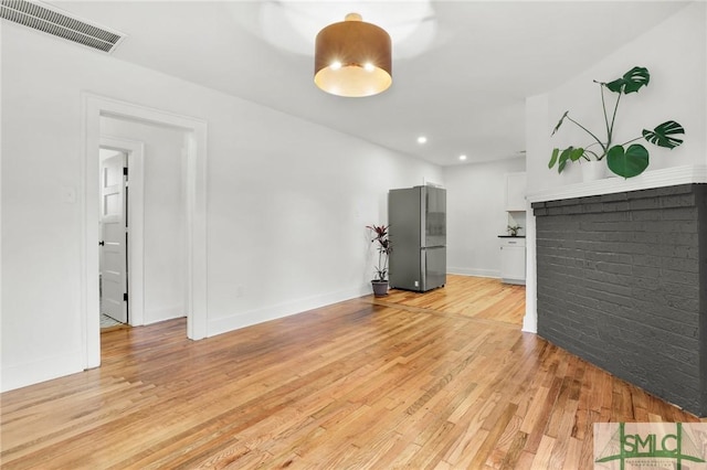 unfurnished living room featuring light wood-type flooring