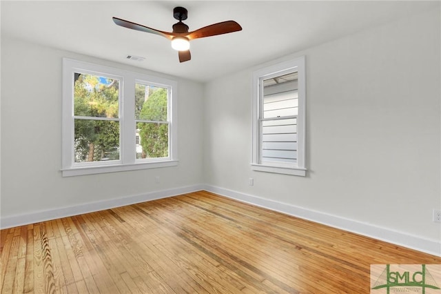 spare room featuring hardwood / wood-style flooring and ceiling fan