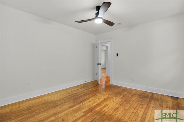 spare room with hardwood / wood-style flooring and ceiling fan