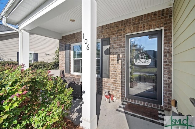 view of exterior entry with a porch