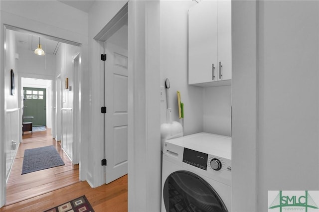 laundry room featuring washer / dryer and light hardwood / wood-style floors