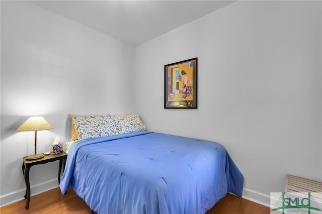 bedroom with hardwood / wood-style flooring