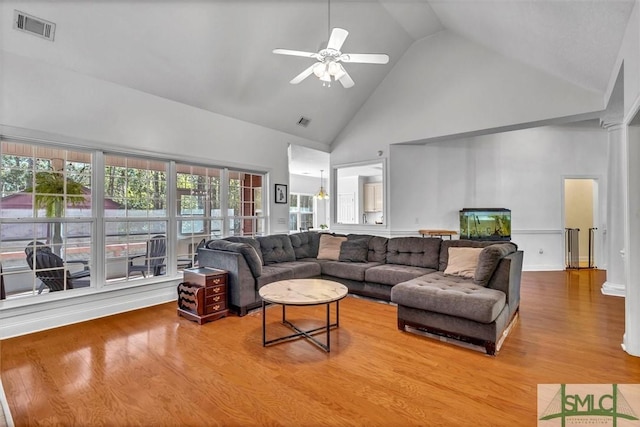 living room with ceiling fan, high vaulted ceiling, and hardwood / wood-style flooring