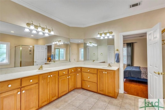 bathroom featuring vanity, tile patterned floors, an enclosed shower, and crown molding