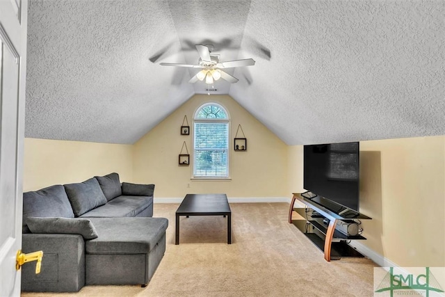 carpeted living room featuring ceiling fan and vaulted ceiling