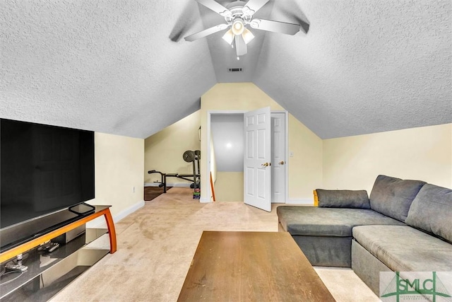 carpeted living room with a textured ceiling, ceiling fan, and vaulted ceiling