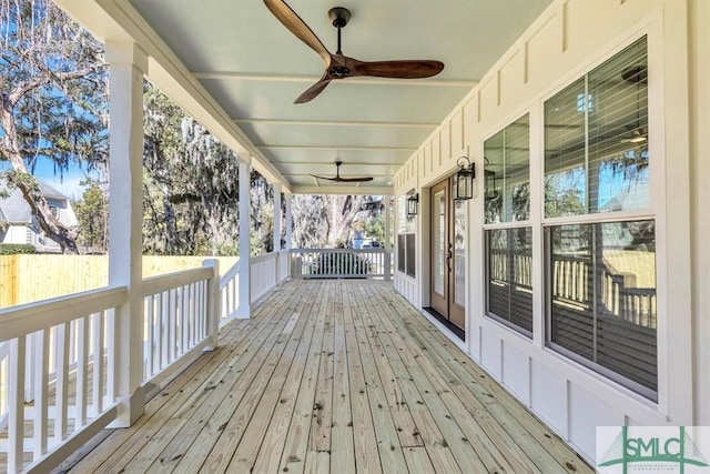 wooden terrace with covered porch and ceiling fan