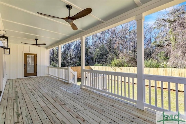 deck with ceiling fan and a yard