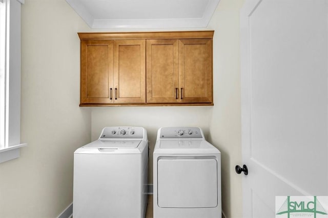 washroom featuring cabinets and washer and clothes dryer