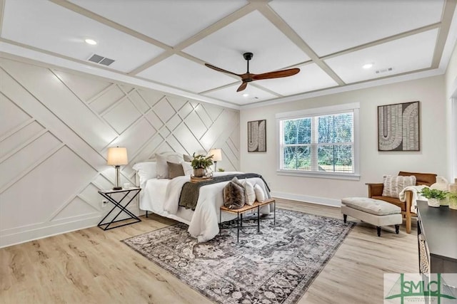 bedroom with light wood-type flooring, ceiling fan, and coffered ceiling