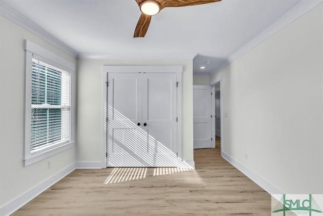 hall featuring light hardwood / wood-style floors and crown molding