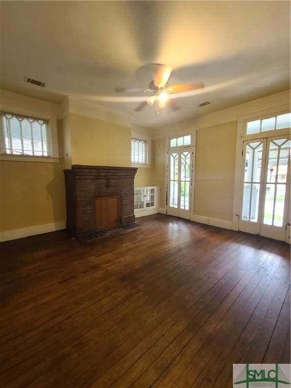 unfurnished living room featuring ceiling fan, dark hardwood / wood-style floors, and french doors