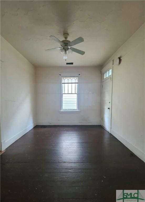 empty room featuring dark hardwood / wood-style floors and ceiling fan