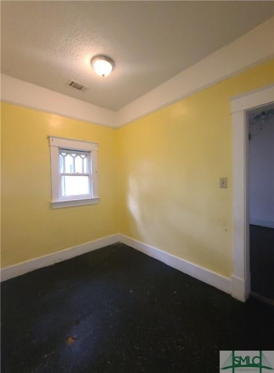 spare room with a textured ceiling