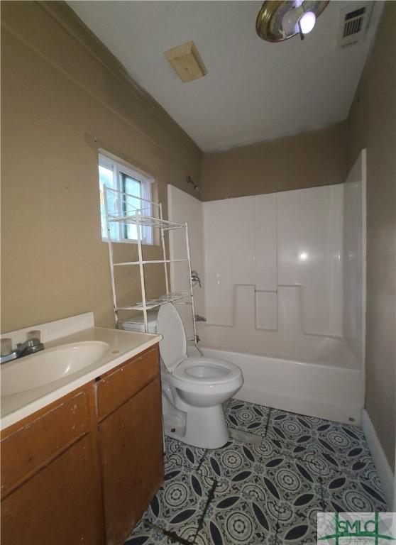 full bathroom featuring tile patterned flooring, vanity,  shower combination, and toilet