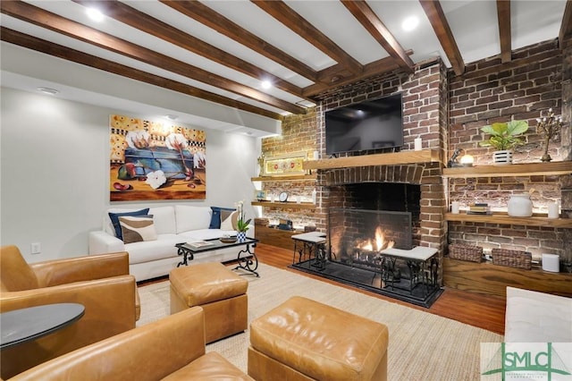 living room featuring beam ceiling, a fireplace, and hardwood / wood-style floors