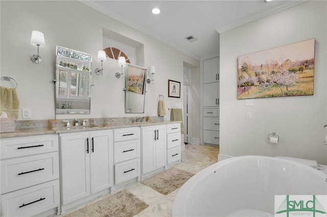 bathroom featuring ornamental molding, vanity, and a bathing tub