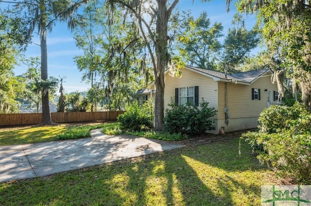 view of side of home with a yard