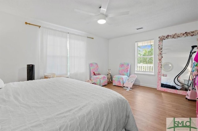 bedroom with ceiling fan and wood-type flooring