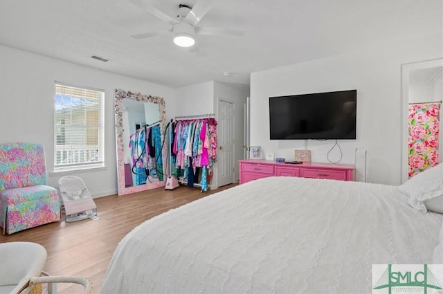 bedroom with ceiling fan, a closet, and dark hardwood / wood-style floors