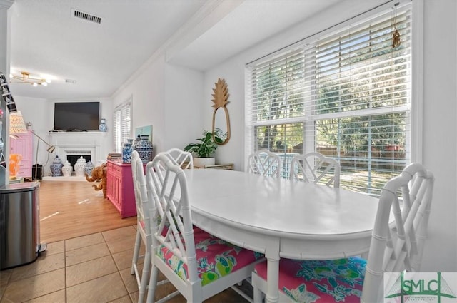 tiled dining room with crown molding