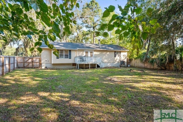 back of property with a lawn and a wooden deck