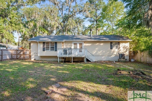 rear view of property with central AC unit, a lawn, and a wooden deck