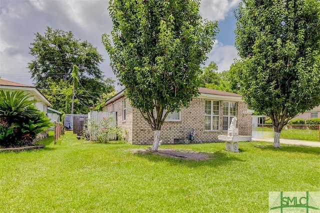 rear view of house featuring a yard