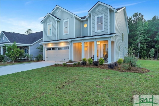 view of front of house with covered porch, a garage, and a front lawn