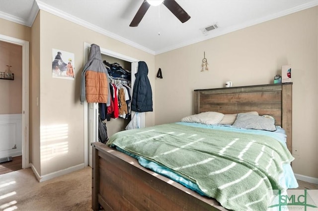 bedroom with light carpet, a closet, ceiling fan, and ornamental molding