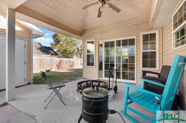 view of patio featuring ceiling fan and an outdoor fire pit