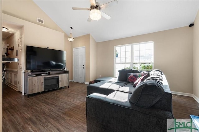 living room with ceiling fan, dark hardwood / wood-style floors, and vaulted ceiling