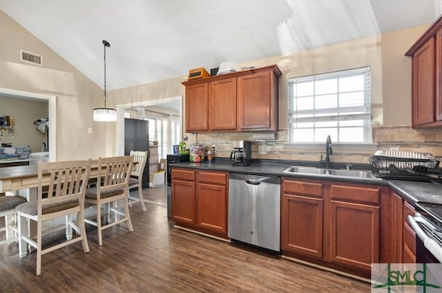 kitchen featuring dishwasher, sink, backsplash, pendant lighting, and vaulted ceiling