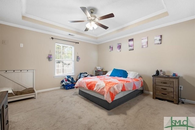 carpeted bedroom featuring a raised ceiling, ceiling fan, and crown molding