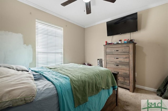 carpeted bedroom featuring ceiling fan and crown molding