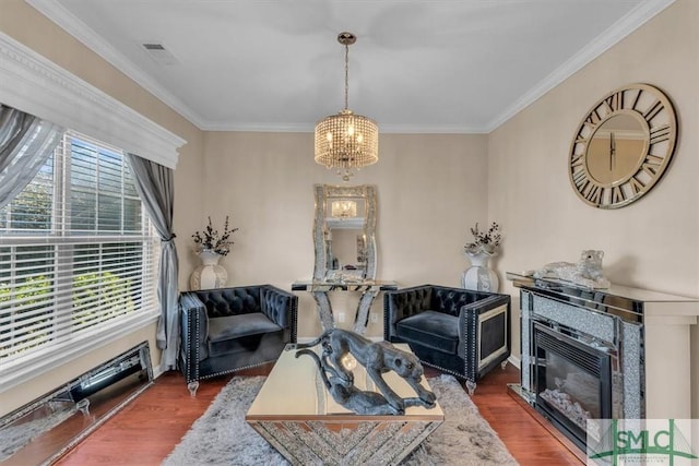 living room with plenty of natural light, dark hardwood / wood-style floors, and a notable chandelier