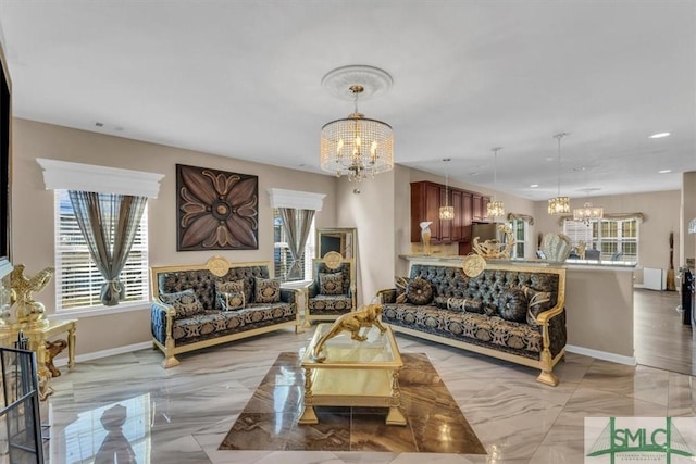 living room featuring an inviting chandelier and a healthy amount of sunlight