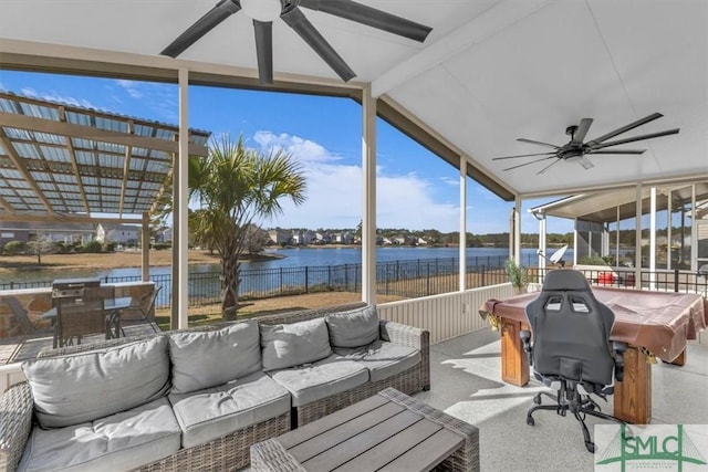 sunroom / solarium featuring a water view, vaulted ceiling with beams, and ceiling fan