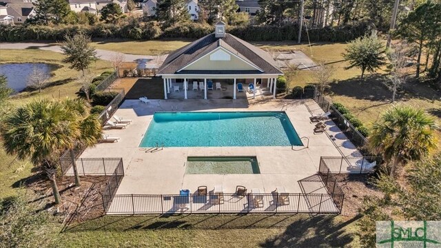 view of pool with a patio and a lawn